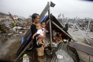  A Filipino father and his children wait for food relief outside their makeshift tent in the super typhoon devastated city ofTacloban, Leyte province, Philippines 10 November 2013. Typhoon Haiyan tore through the eastern and central Philippines beginning 08 November, flattening homes, toppling power lines and knocking out communications. Fierce winds ripped roofs off buildings as raging floodwaters swept debris and left vehicles piled on top of each other on the battered streets. The official death toll was 138, according to the national disaster relief agency. But official said, the toll could reach 10,000 in one city alone. EPA/DENNIS M. SABANGAN